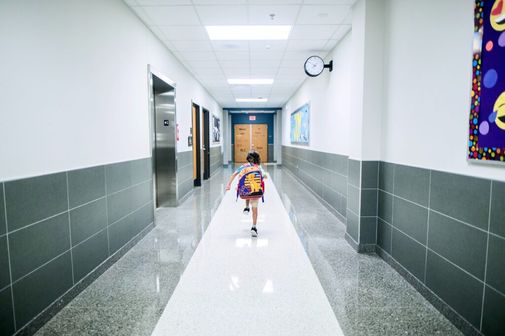 girl running down a school hallway